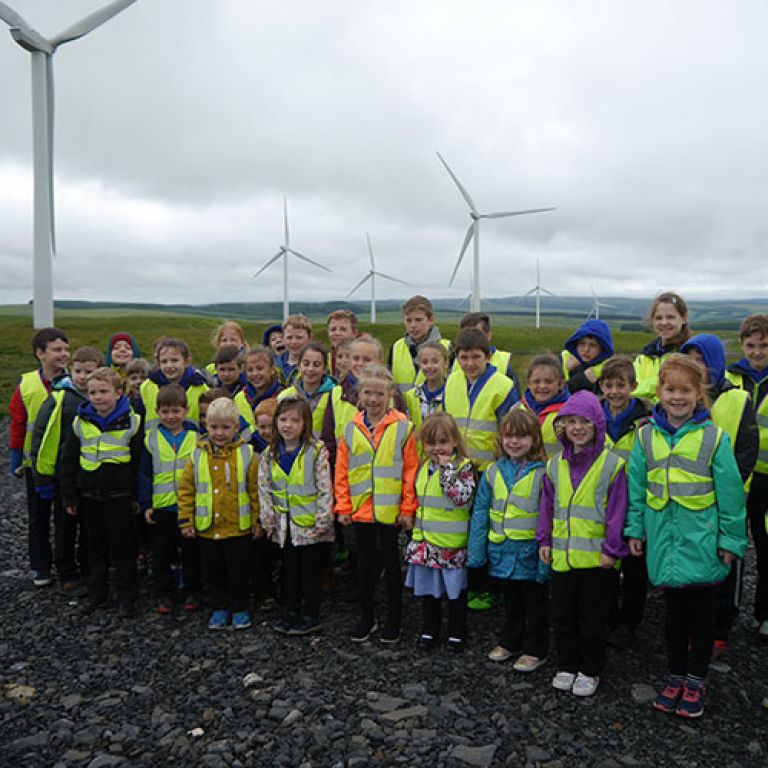 Group of school children at a wind farm